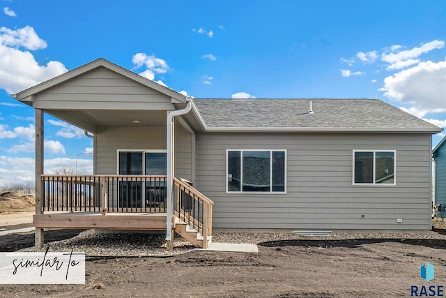 rear view of house featuring a deck