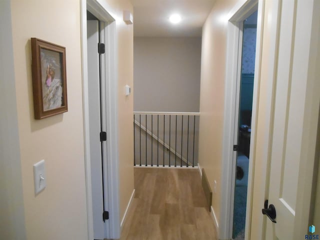 corridor with light hardwood / wood-style flooring