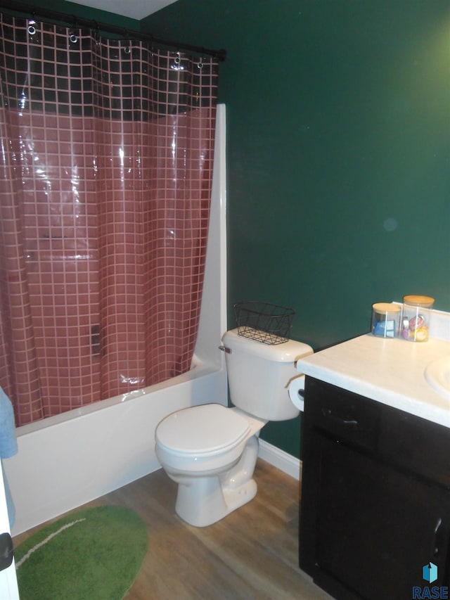 full bathroom featuring shower / bath combo with shower curtain, toilet, vanity, and hardwood / wood-style flooring