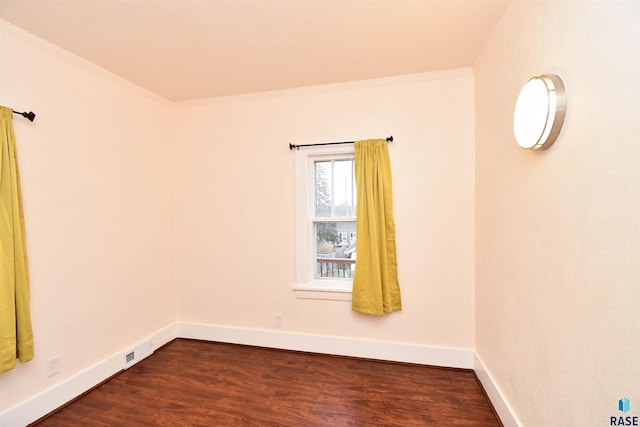 spare room featuring dark hardwood / wood-style floors