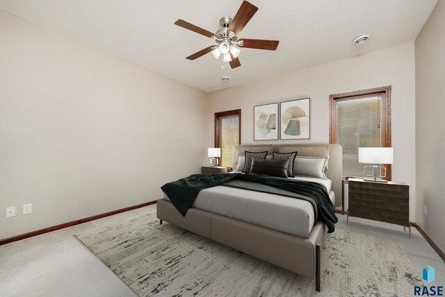 bedroom featuring multiple windows and ceiling fan