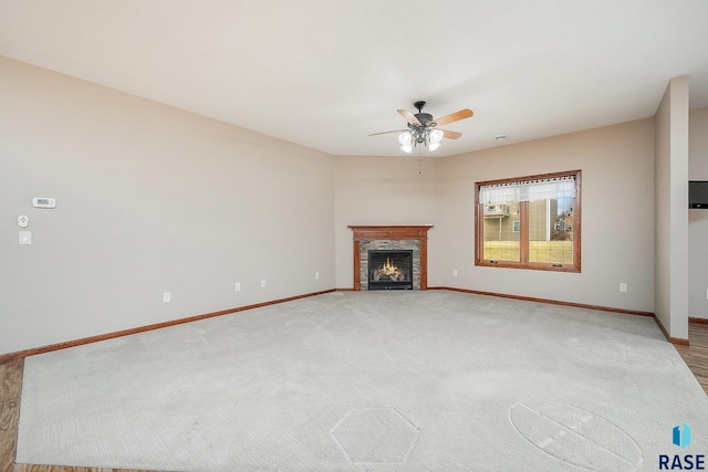 unfurnished living room featuring ceiling fan and light colored carpet