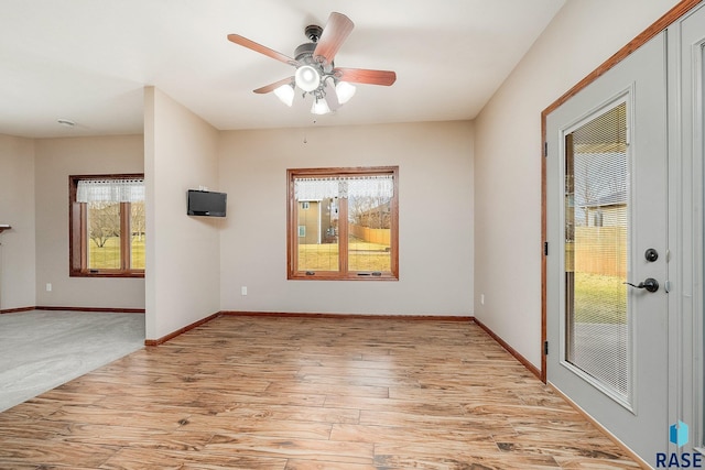 unfurnished room with light hardwood / wood-style flooring and ceiling fan