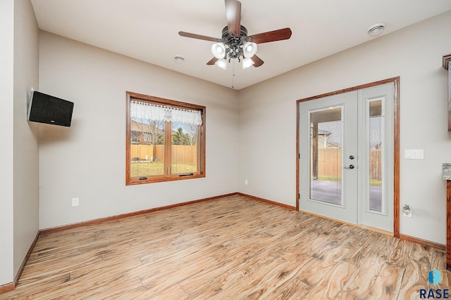 spare room featuring ceiling fan, light hardwood / wood-style floors, and french doors