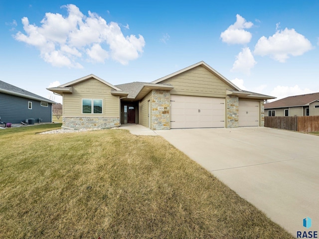 ranch-style home featuring a front yard and a garage