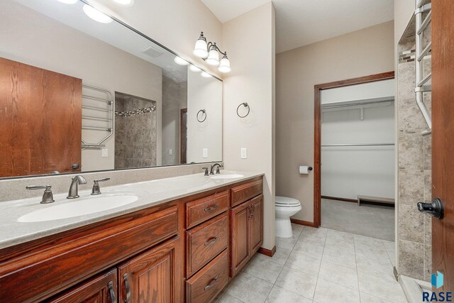 bathroom featuring tile patterned flooring, vanity, and toilet