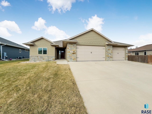 ranch-style home with a garage and a front lawn