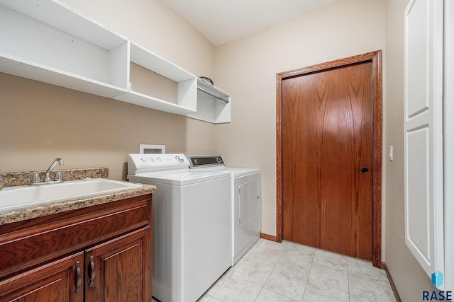 laundry area featuring cabinets, independent washer and dryer, sink, and light tile patterned floors