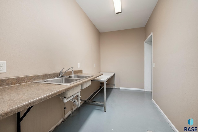 kitchen featuring sink and concrete floors