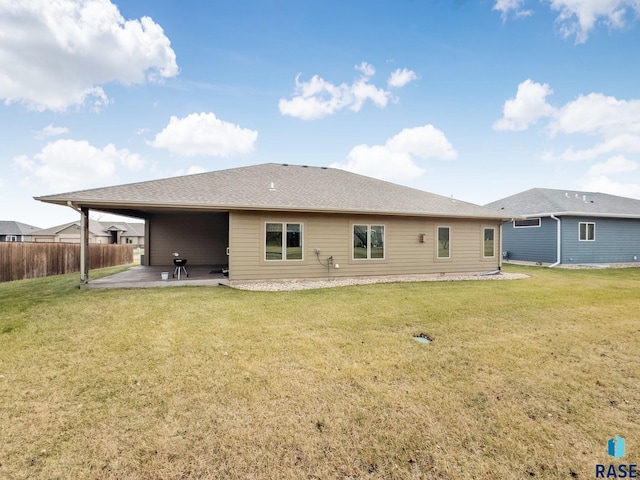 rear view of property with a lawn and a patio