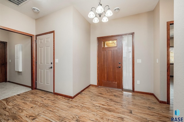 entryway featuring a notable chandelier and light hardwood / wood-style flooring