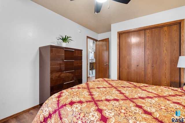 bedroom with ceiling fan, a closet, and wood-type flooring