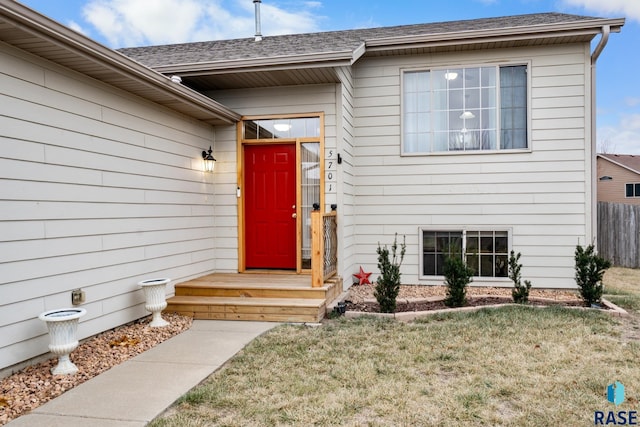 doorway to property with a yard