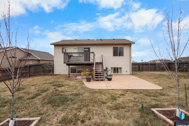 rear view of house featuring a patio area, a yard, and a deck