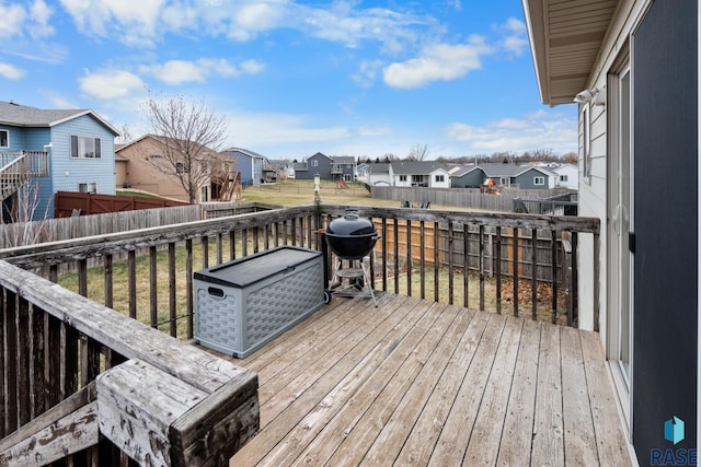 wooden terrace with grilling area and a lawn