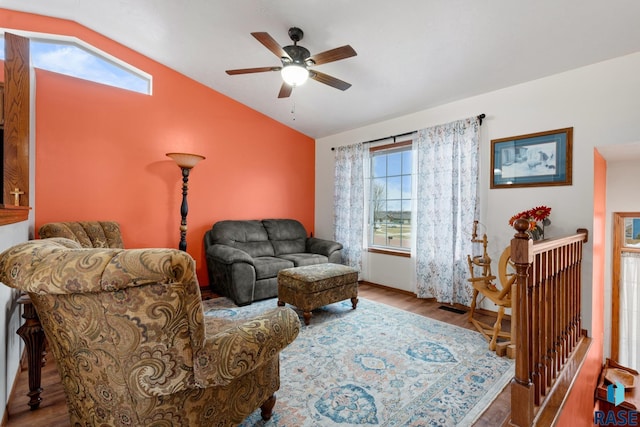 living room with a healthy amount of sunlight, hardwood / wood-style flooring, ceiling fan, and lofted ceiling