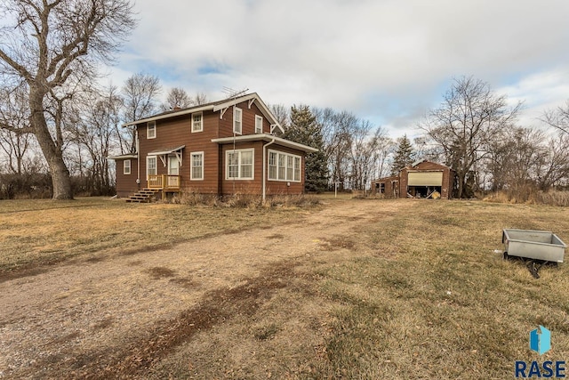 view of home's exterior featuring an outdoor structure and a lawn