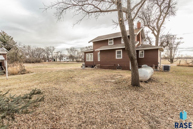 view of home's exterior featuring central AC unit and a lawn