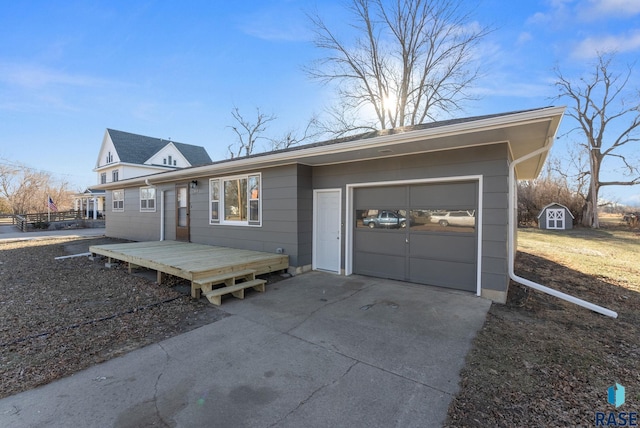 view of front facade featuring a deck, a storage unit, and a garage