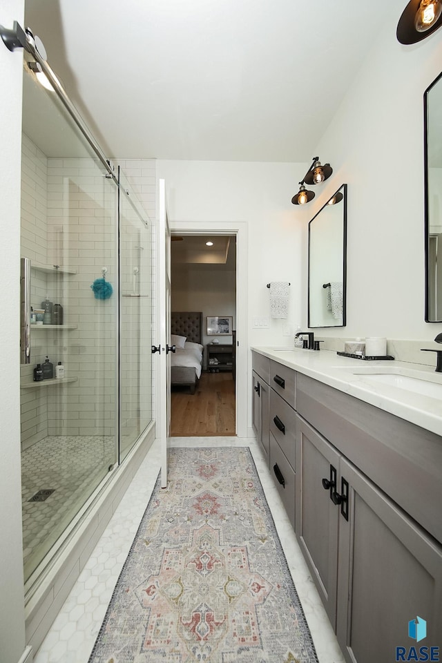 bathroom featuring tile patterned flooring, vanity, and a shower with shower door