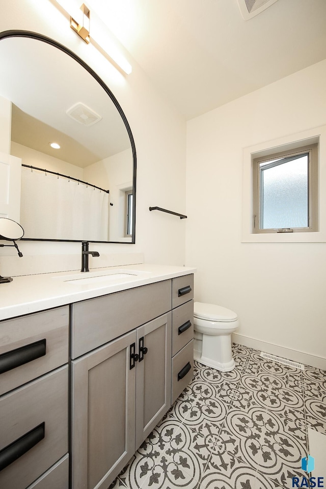 bathroom featuring tile patterned floors, vanity, and toilet