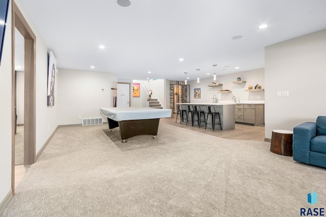 playroom featuring light carpet, billiards, and wet bar