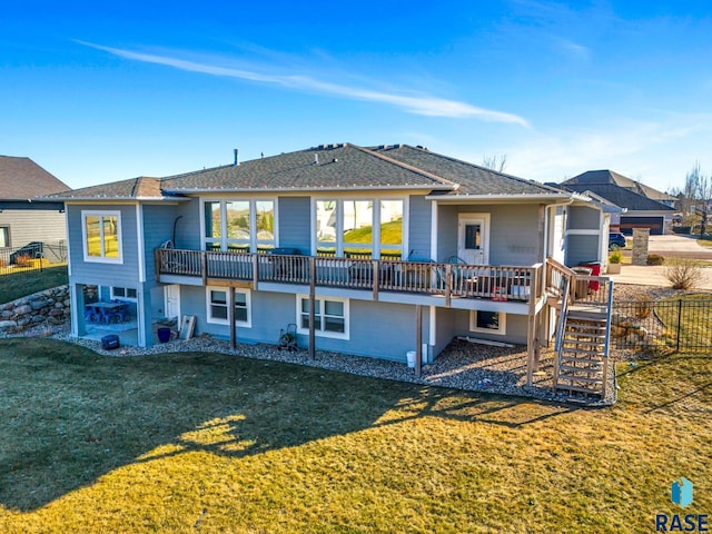 back of house with a lawn and a deck