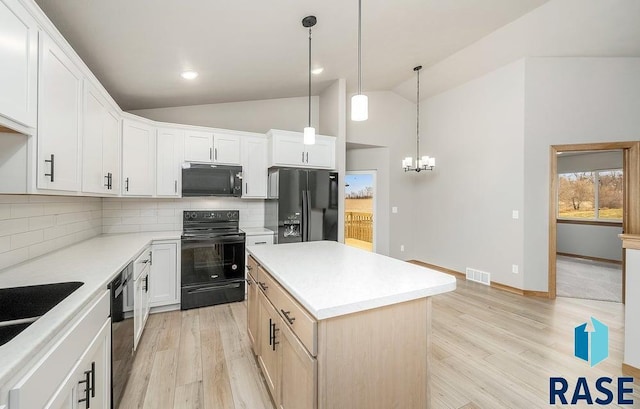 kitchen with black appliances, white cabinets, hanging light fixtures, decorative backsplash, and a kitchen island