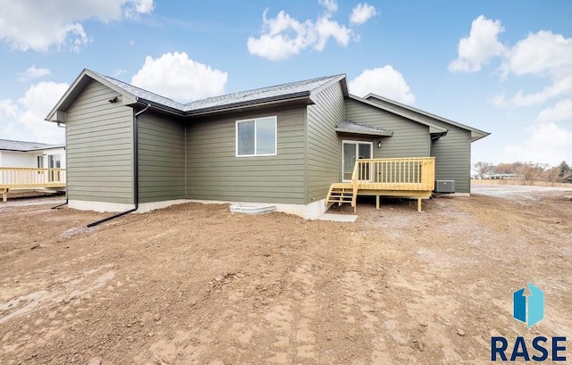 back of property featuring central air condition unit and a deck