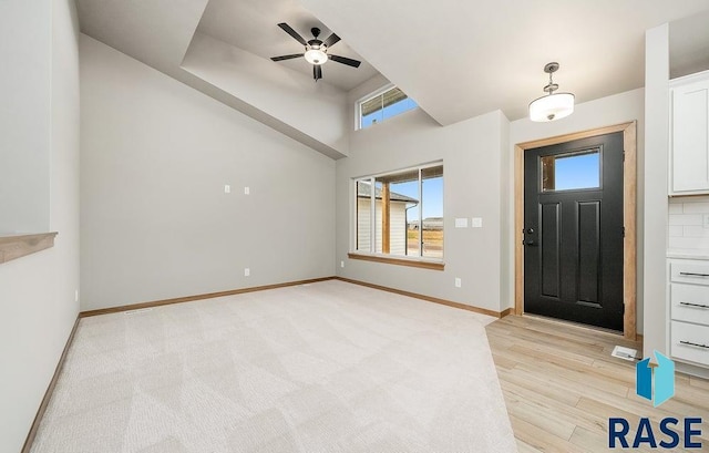 foyer with ceiling fan and light wood-type flooring