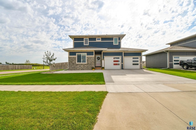 view of front of property with a garage and a front lawn