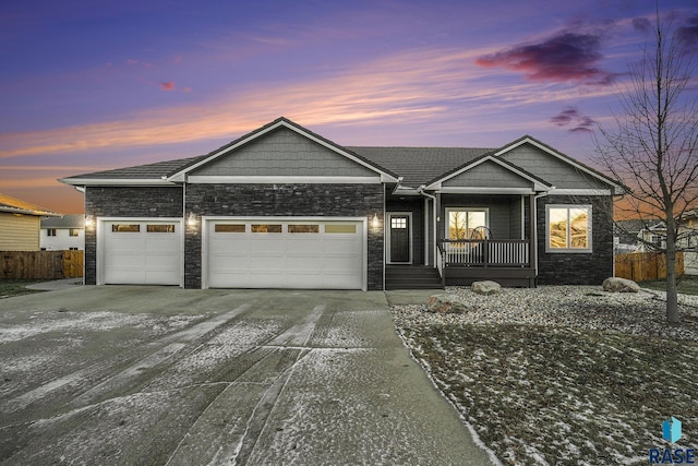 view of front of home featuring a porch and a garage