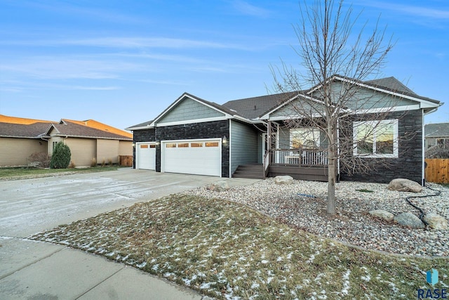 ranch-style home with a porch and a garage