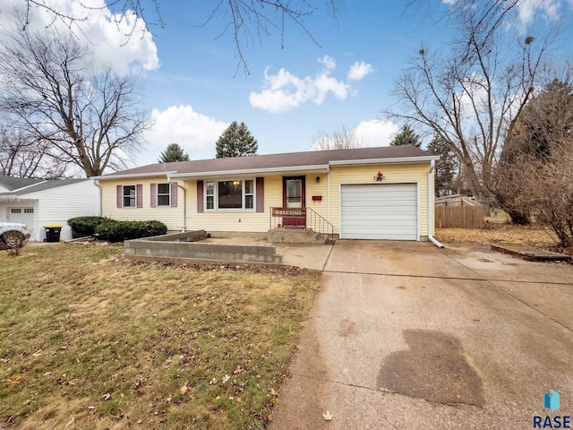 ranch-style home featuring a garage and a front lawn