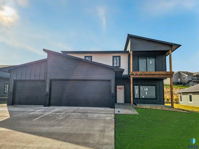 contemporary home with a front yard and a garage