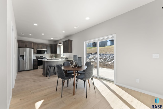 dining area featuring light hardwood / wood-style flooring and sink