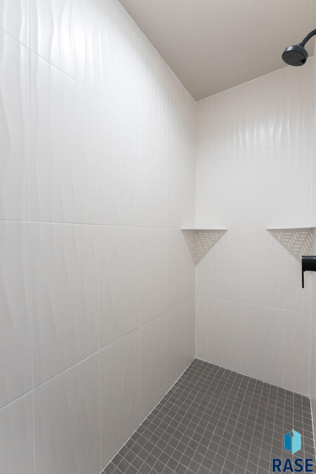 bathroom with a tile shower