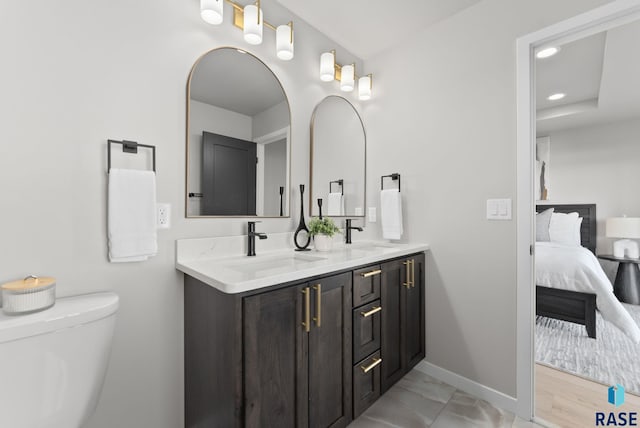 bathroom featuring hardwood / wood-style flooring, vanity, and toilet