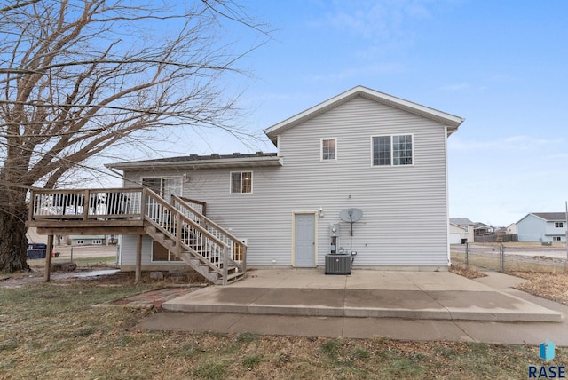 rear view of house featuring a wooden deck, a patio, and central AC unit