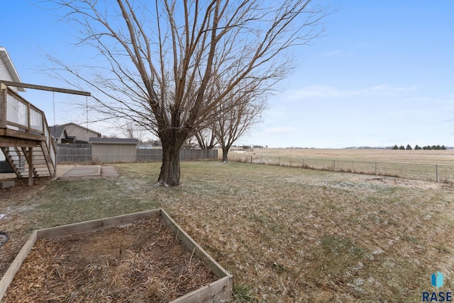 view of yard with a rural view and a deck