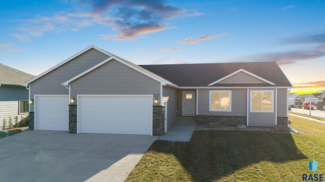 view of front of house with a garage and a yard