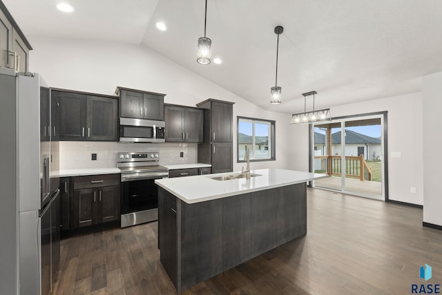 kitchen featuring hanging light fixtures, sink, vaulted ceiling, dark hardwood / wood-style floors, and appliances with stainless steel finishes