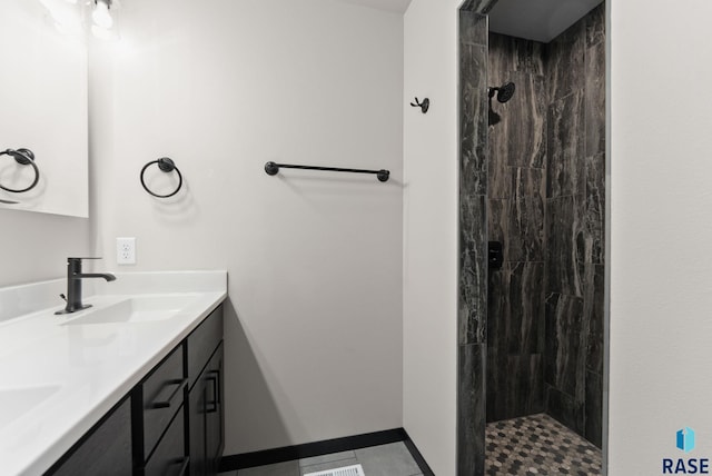 bathroom featuring vanity and tiled shower