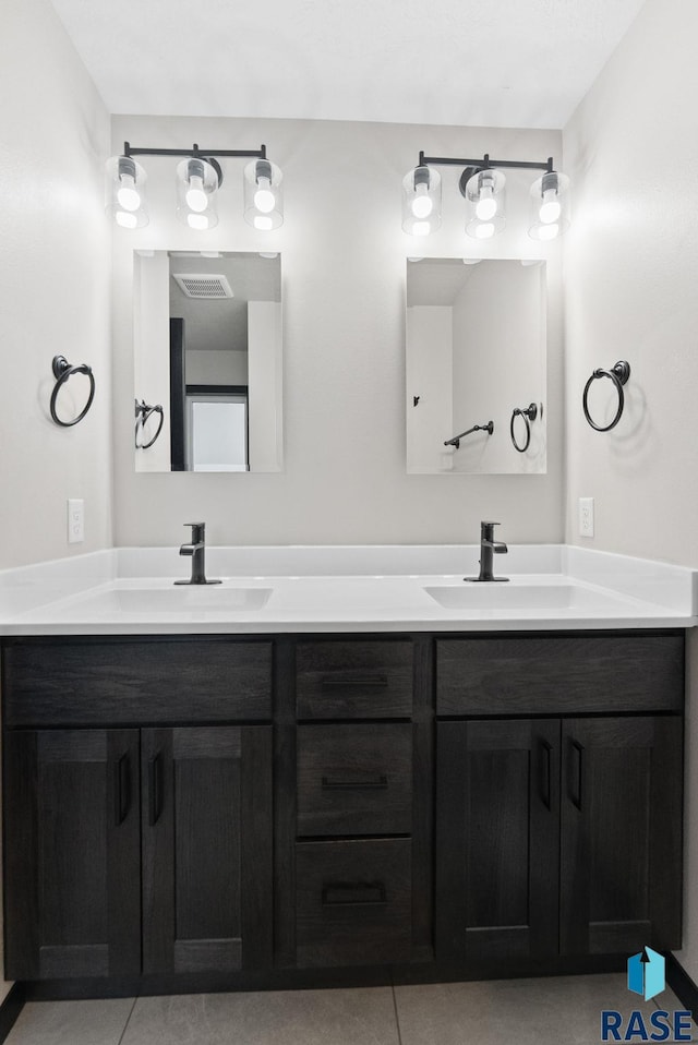 bathroom with tile patterned floors and vanity