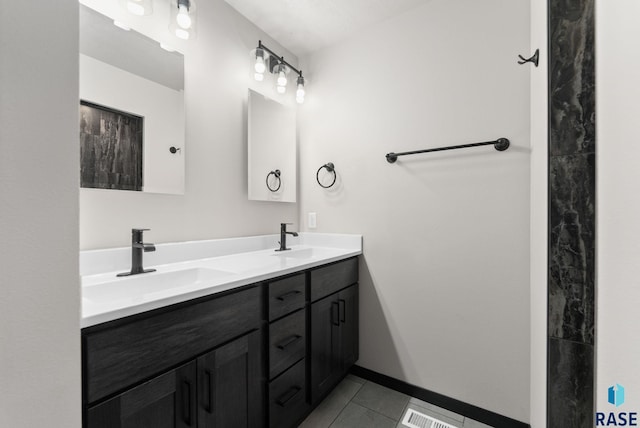 bathroom featuring tile patterned flooring and vanity