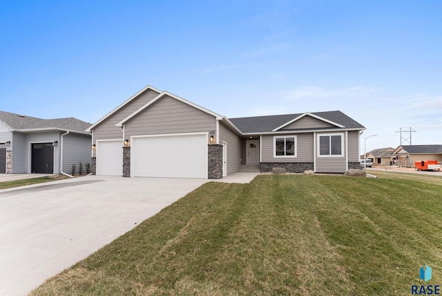 ranch-style house featuring a garage and a front lawn