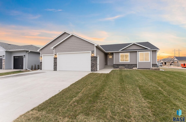 single story home featuring a garage and a lawn