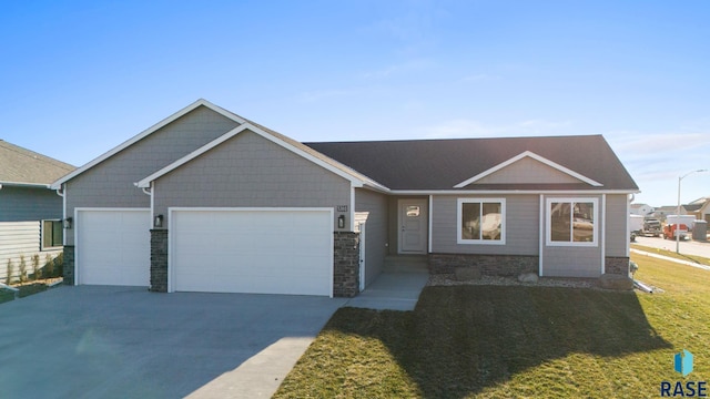 view of front of house with a garage and a front lawn