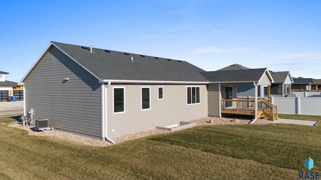 rear view of house with a yard and a deck