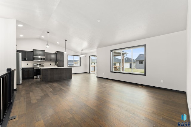 living room featuring vaulted ceiling, sink, and dark hardwood / wood-style floors